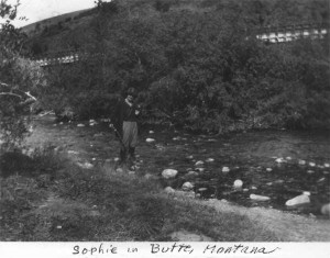 Sophie in Butte, MT standing beside river. (1922)